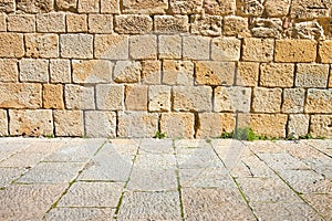 Old medieval italian stone wall, built with splitted blocks, recently restored