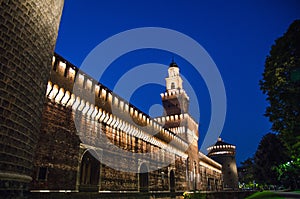 Old medieval Sforza Castle Castello Sforzesco lightning facade, walls, tower La torre del Filarete in Milan