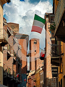 Old medieval tower among historic buildings in Alba, Italy