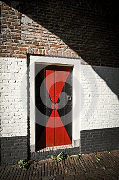 Old medieval wooden door with painted decoration in the city gate of Tower or Zuidhavenpoort in Zierikzee