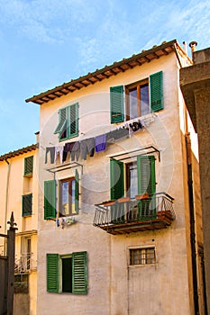 Old Mediterranean house with laundry clothes hanged and drying in a line.