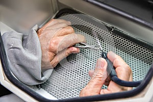 Old men hands working with with tooth prosthesis in a dental sa