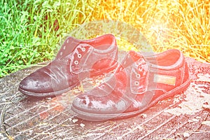 Old men`s shoes. Abandoned on the street after a rain. Worn and