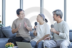 Old men and women karaoke in the living room. Senior friends group hangout, Older people meeting