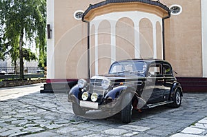 Old Mercedes car in front of church