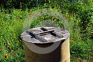 Old metal barrel with wooden lid