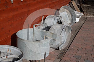 Old metal bathtub based on a wooden wall. Accessories for person