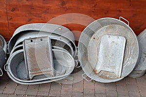 Old metal bathtub based on a wooden wall. Accessories for person