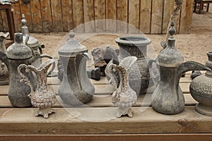 Old metal bedouin coffee pots and jugs for water in one of the m