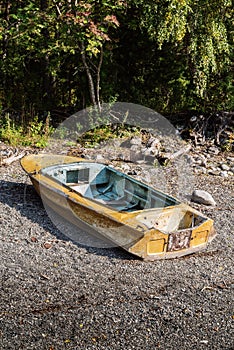 An old metal boat pulled ashore photo