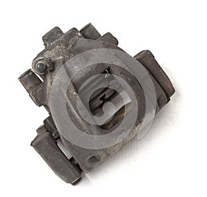 Old metal brake caliper on a white background in a photo studio for replacement during the repair of the chassis or for a catalog