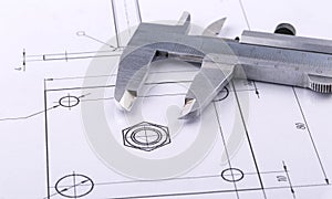 Old metal caliper and engineering drawing.