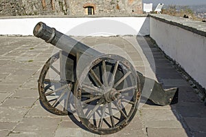 Old metal cannon on the wall of the fortress