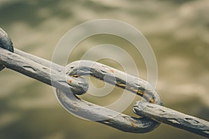 Old metal chain links/old metal chain links on a water background