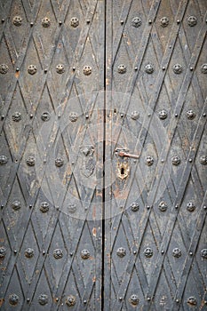 Old metal-decorated church door - detail texture - handle and keyhole