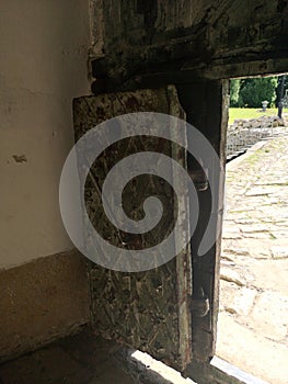 An old metal door in the brick wall