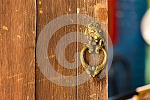 old metal door handle knocker on wood door