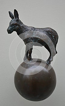 Old metal door handle made as small donkey statue
