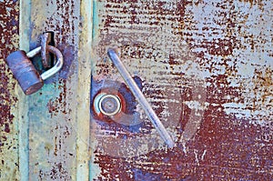 Old metal door painted with gray paint with rust and cracks close-up