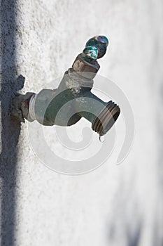 Old metal dripping exterior tap