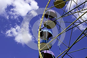 An old metal ferris wheel without people. Carousel, swings, amusement park