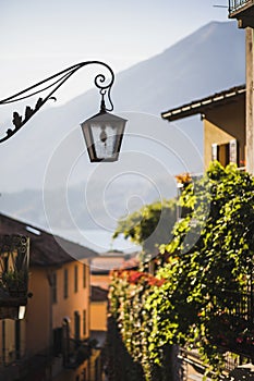 Old metal forged lantern on cozy european street. Old city architecture details