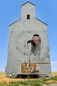 Old metal grain elevator on the prairie in Montana, USA