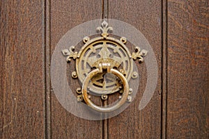 Old metal handle of a wooden door in a vintage style