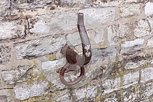 Old metal hook in the wall at berth