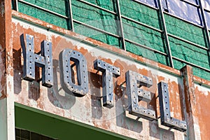 Old metal Hotel sign in need of repair