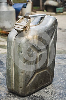 Old metal jerrycan or gasoline canister fuel can