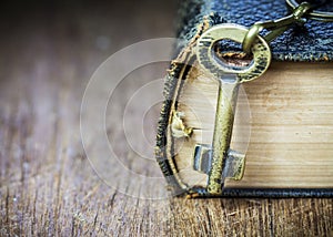 Old metal key on the old holy bible