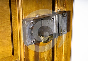 Old metal keylock on retro wooden door