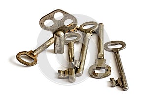 Old metal keys from long-lost locks on a white background