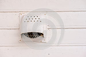 Old metal kitchen vent on a wooden house..
