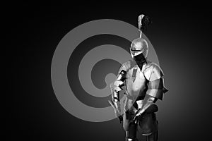 Old metal knight armour on a black background