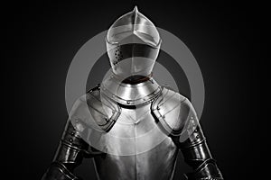 Old metal knight armour on black background