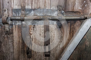 Old metal latch on a wooden door