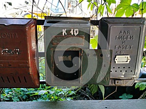 Old metal mailboxes. The inscription on the boxes in Russian from left to right Mail, apt. 10, For letters and newspapers, apt.,