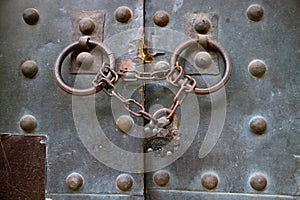 Old metal medieval door with chain lock