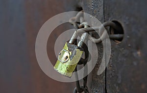 Old metal padlock on a wooden door