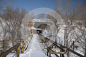 an old metal pier on the frozen Volga river. Syzran