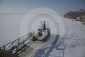 an old metal pier on the frozen Volga river. Syzran