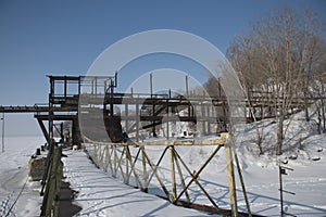 an old metal pier on the frozen Volga river. Syzran