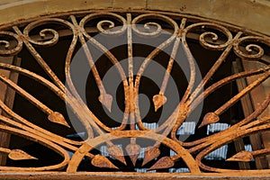 An old metal railing on a wooden door