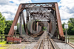 An old metal railroad bridge belonging to the Allegheny Railroad crossing the Allegheny River in Warren, Pennsylvania, USA