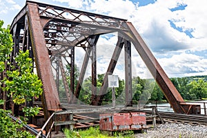 An old metal railroad bridge belonging to the Allegheny Railroad crossing the Allegheny River in Warren, Pennsylvania, USA
