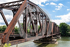 An old metal railroad bridge belonging to the Allegheny Railroad crossing the Allegheny River in Warren, Pennsylvania, USA