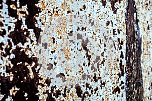 Old metal rusted wall partly covered with peeling paint. Grunge texture and background. Close-up