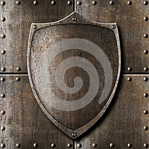Old metal shield over armour background